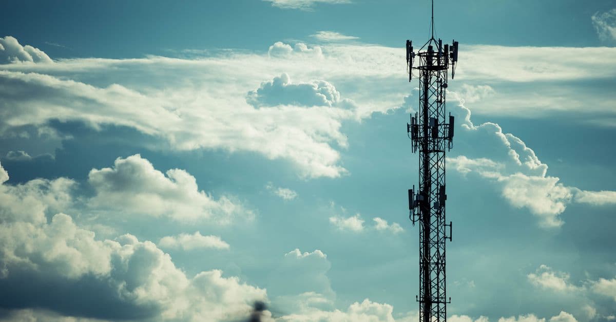 An antenna mast against the sky, evoking the reference station whose distance sets the RTK baseline